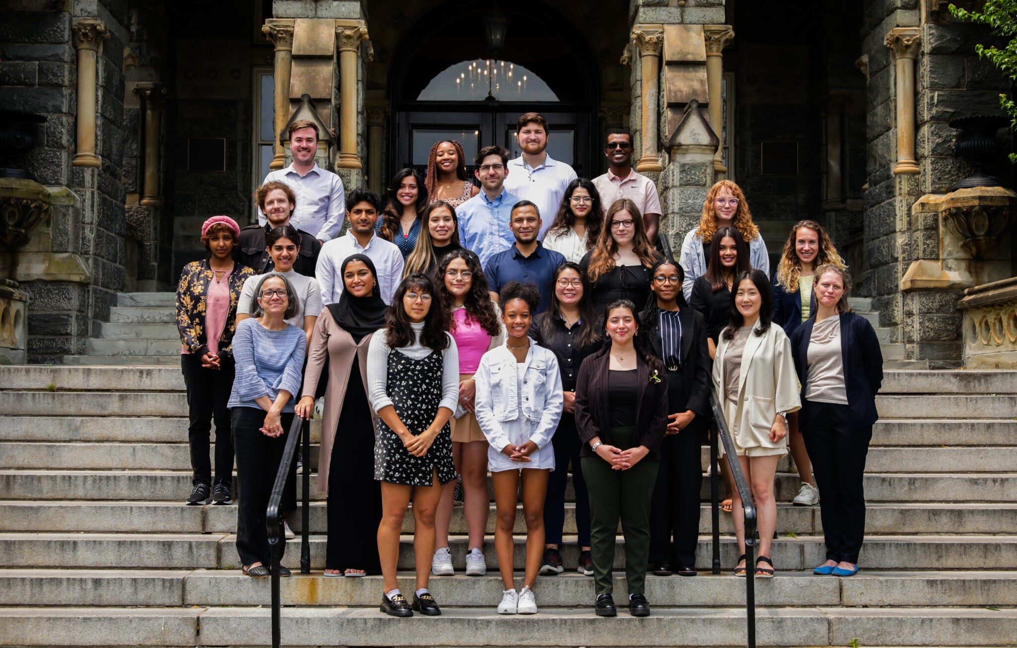 An Institute cohort with faculty and mentors on the steps of Healy Hall at Georgetown University